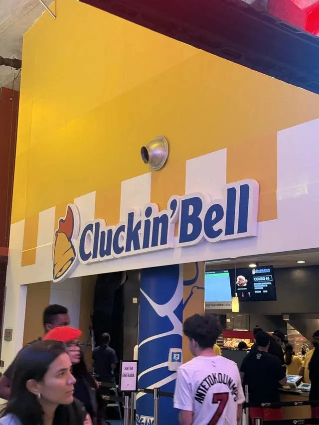 Cluckin’ Bell concession stand and customers at Miami’s Kaseya Center